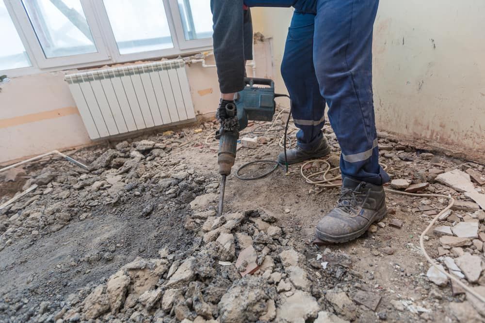 Person Using a Jackhammer to Break Up Debris on a Floor — Clearspan Builders In Bungendore, NSW