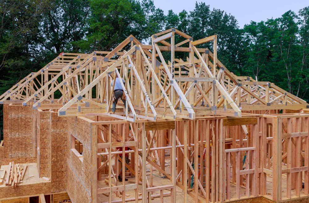 Construction of a House: Wood Frame, Roof Trusses Being Installed — Clearspan Builders In Yass, NSW