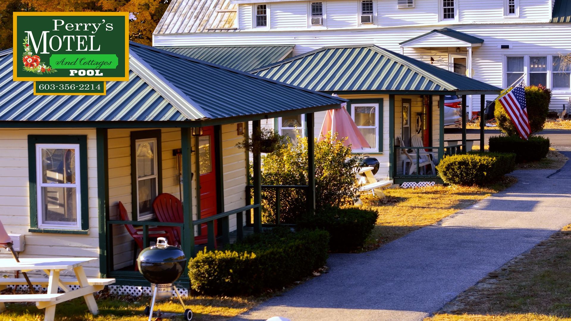 A sign for perry 's motel is above a row of houses