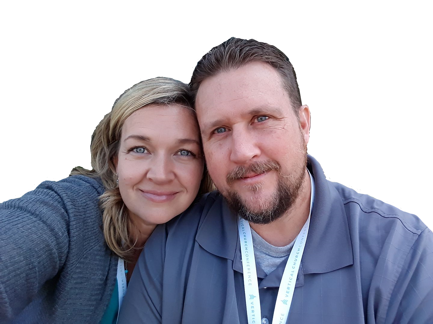 Smiling couple, woman with blonde hair, man with beard, close-up, outdoors.