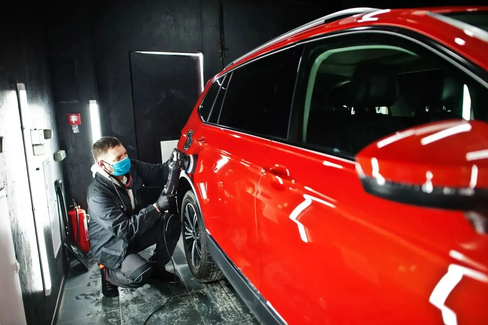 auto paint repair tech buffing vehicle