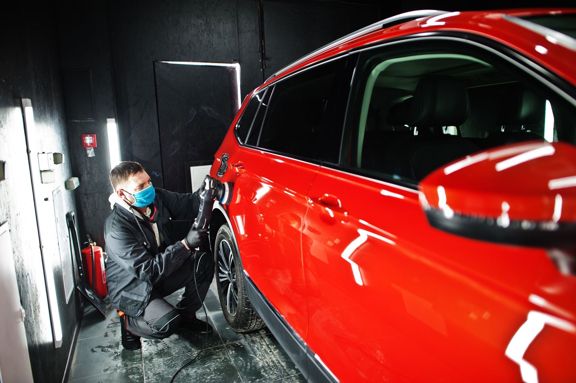 a person polishing the paint of a car