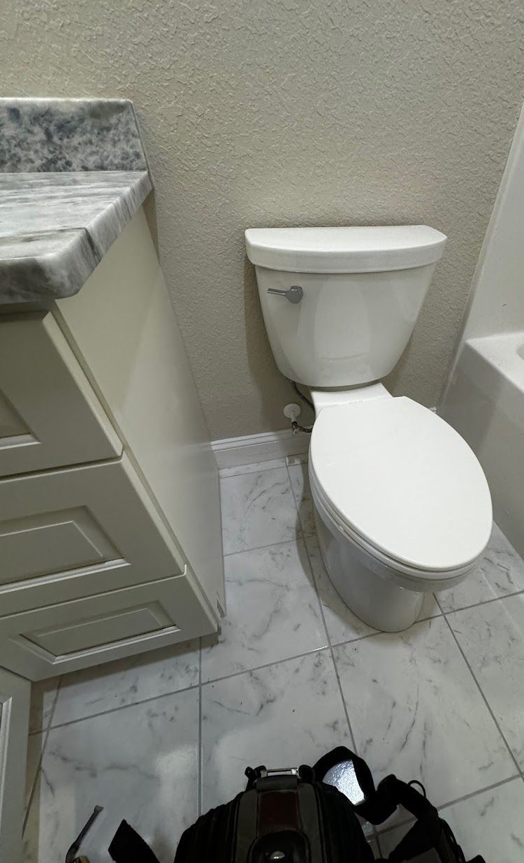 Prestige Plumbing LLC- a bathroom with a toilet , sink , and bathtub.