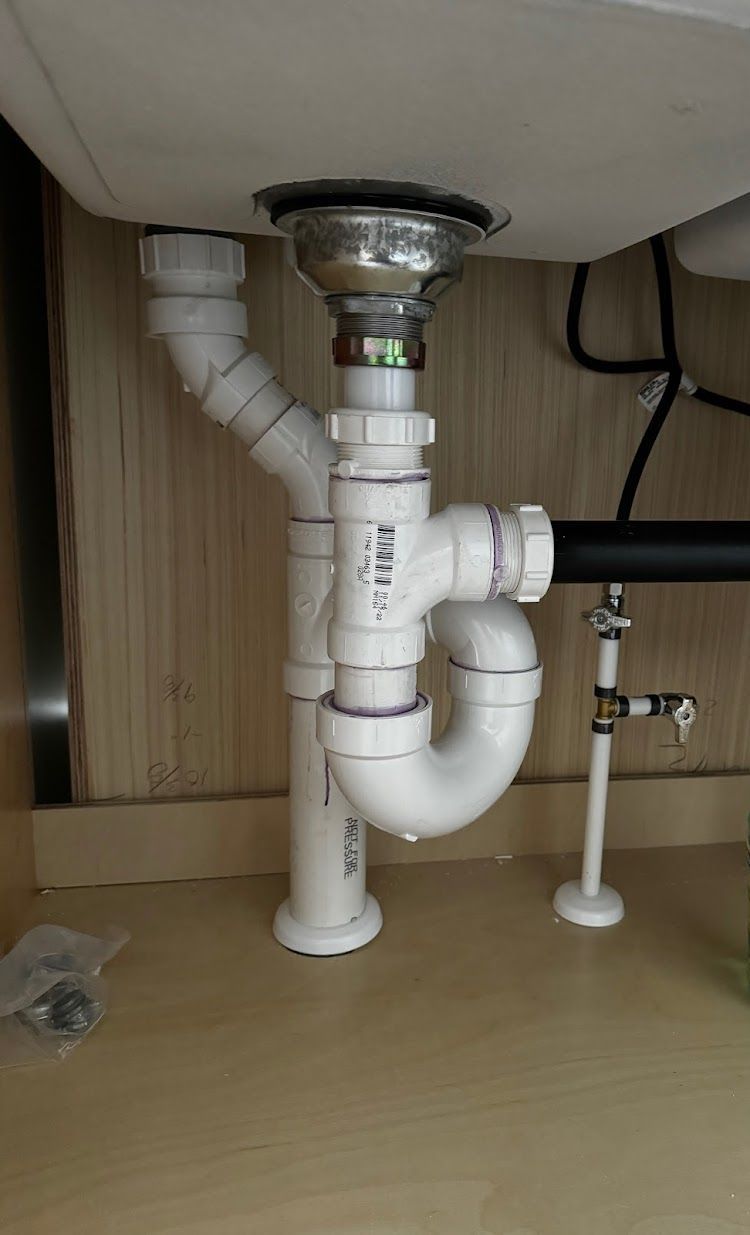 Prestige Plumbing LLC- a sink with a drain pipe underneath it.