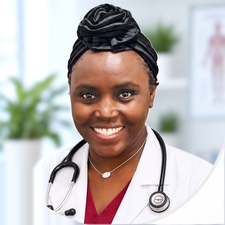 A professional in a white lab coat and blue scrubs standing with arms crossed, holding a stethoscope.
