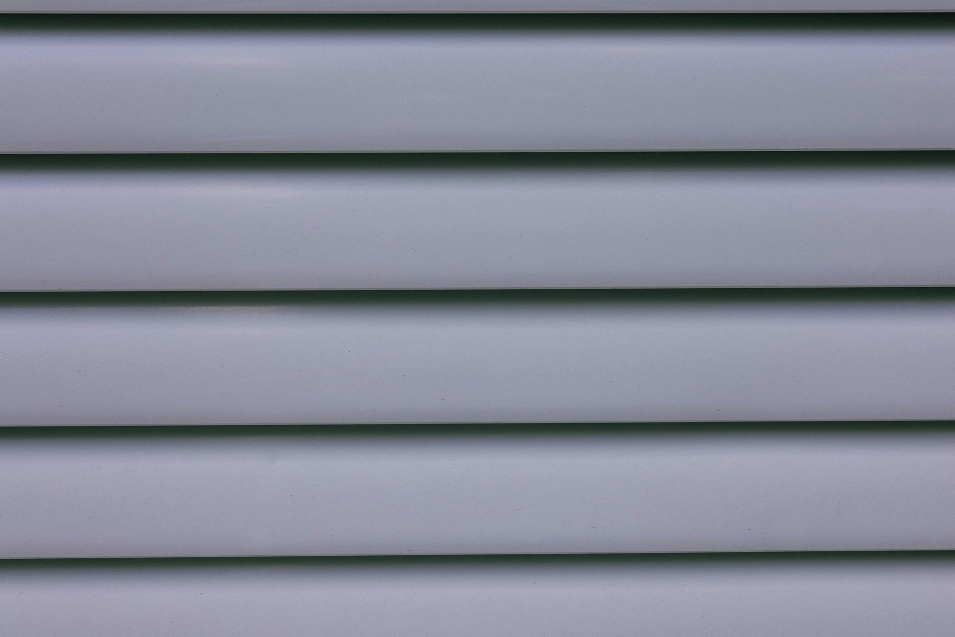 Horizontal, light gray plastic siding.
