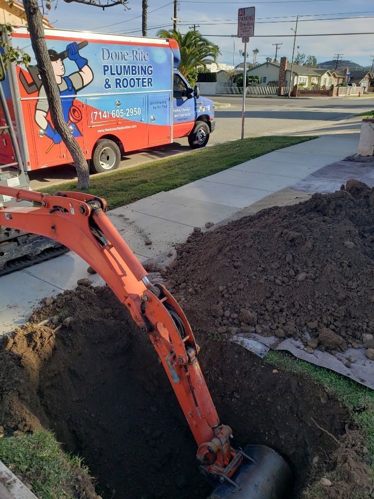 a done right plumbing and rooter truck is parked on the side of the road and a trenchless sewer line repair is being done
