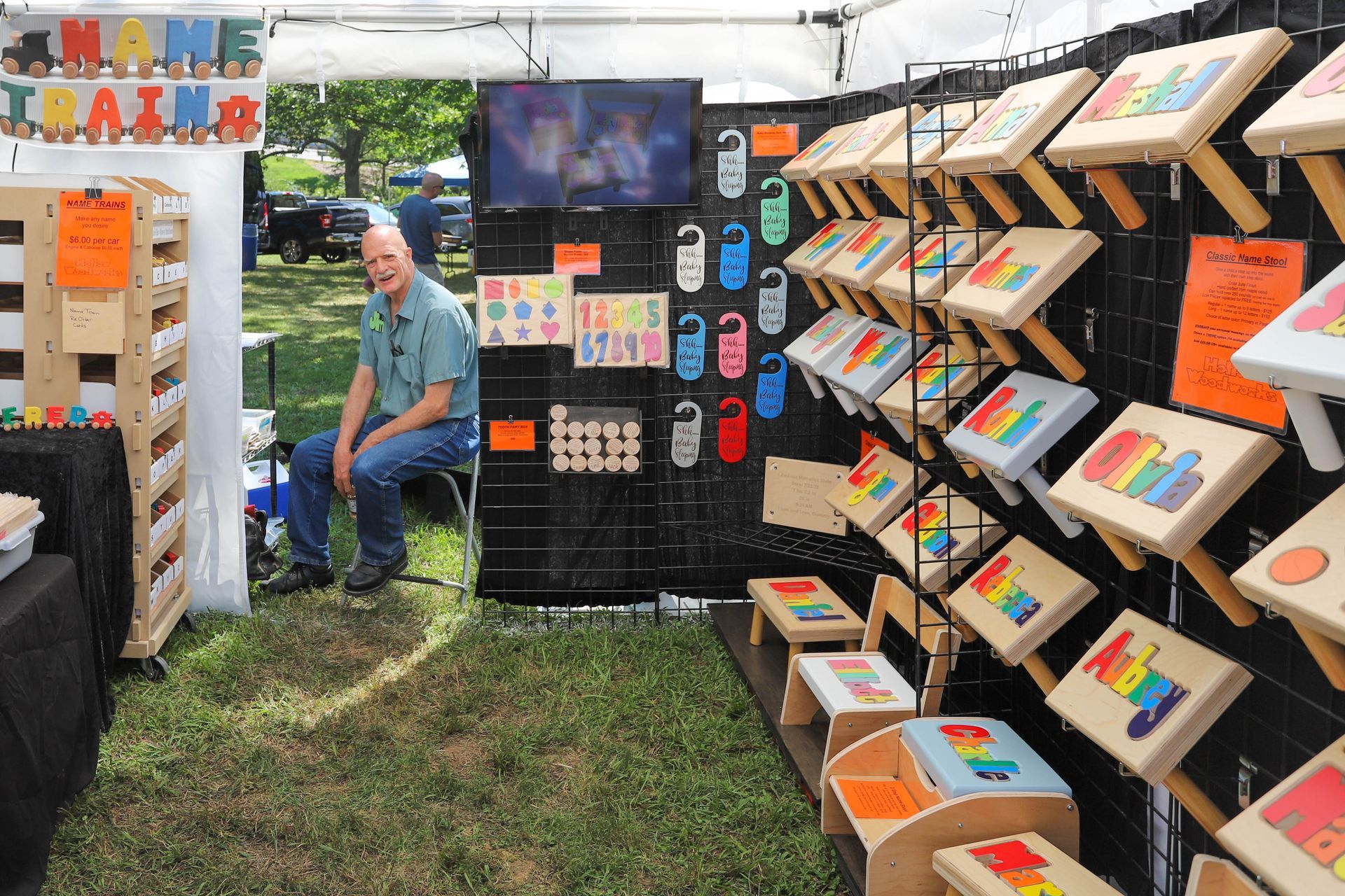 Hollow Woodworks booth at the Greentree Festival showing all the different handmade wooden products they offer. 