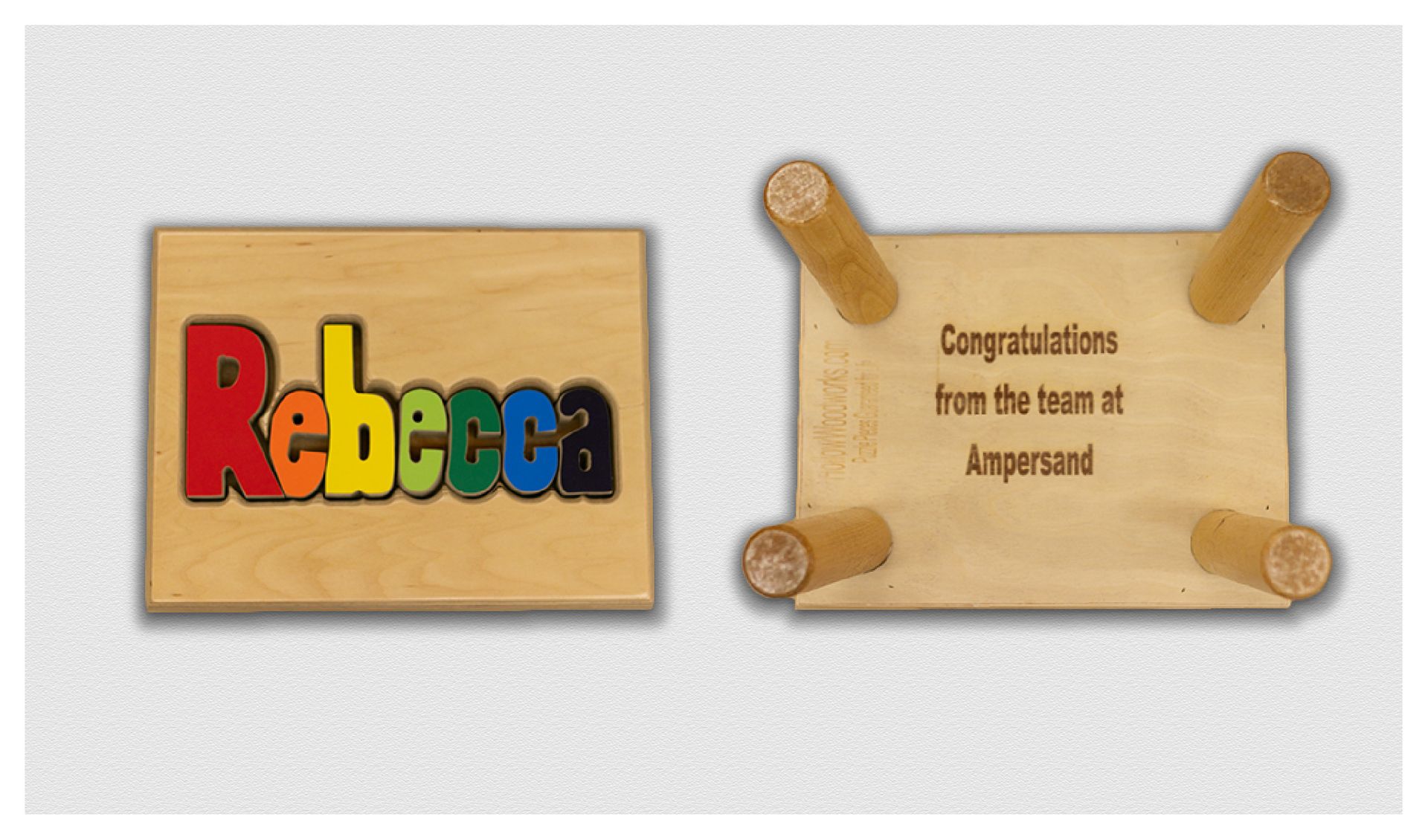 Wooden signs: colorful “Rebecca” on left, and “Congratulations from the team at Ampersand” on right.