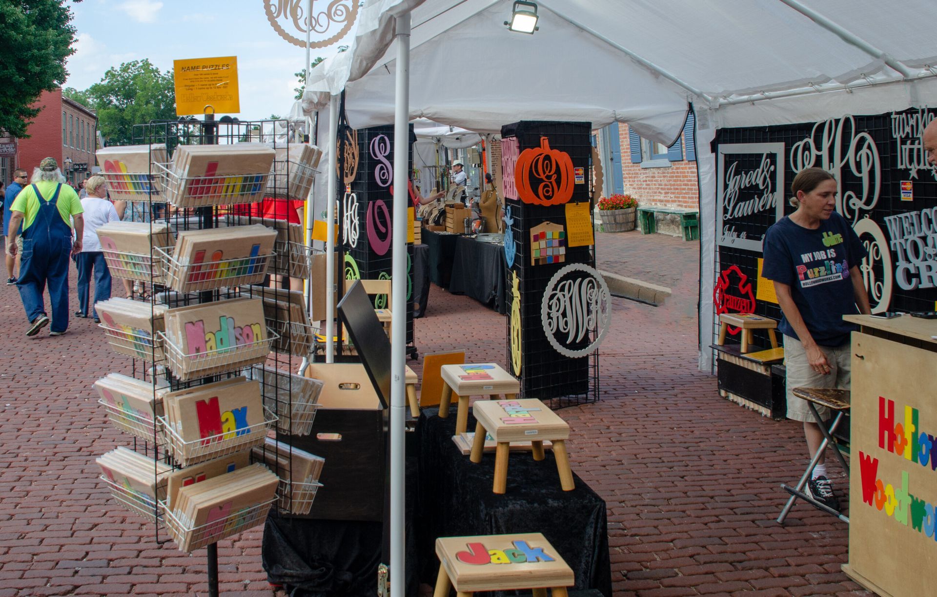 Hollow Woodworks set up a tent, puzzle stools, and other products at an event. 
