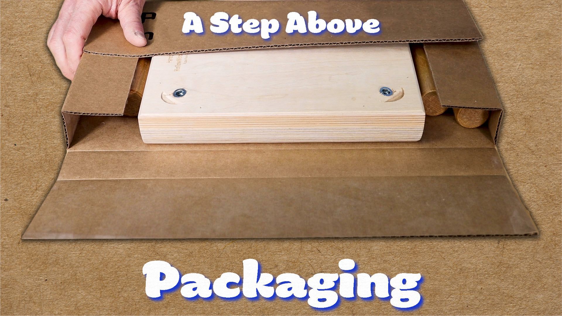 Open cardboard packaging with a wooden block inside and the text “A Step Above Packaging”