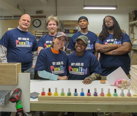 Team picture showing all the employees at the hollow woodworks puzzle shop