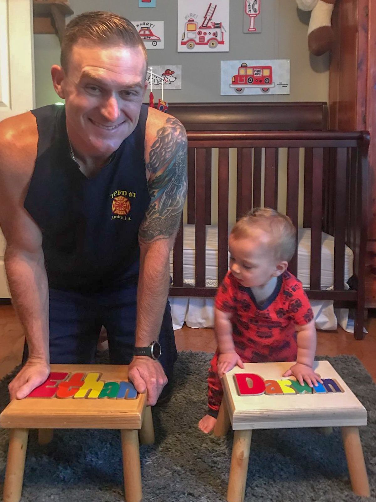 A man and a toddler are showing generational puzzle stools with colorful toy blocks in a nursery. 