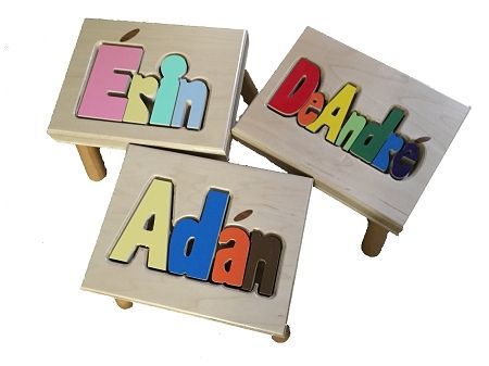 Colorful wooden name puzzles spelling Ethan, Dan, and Adam on small tables