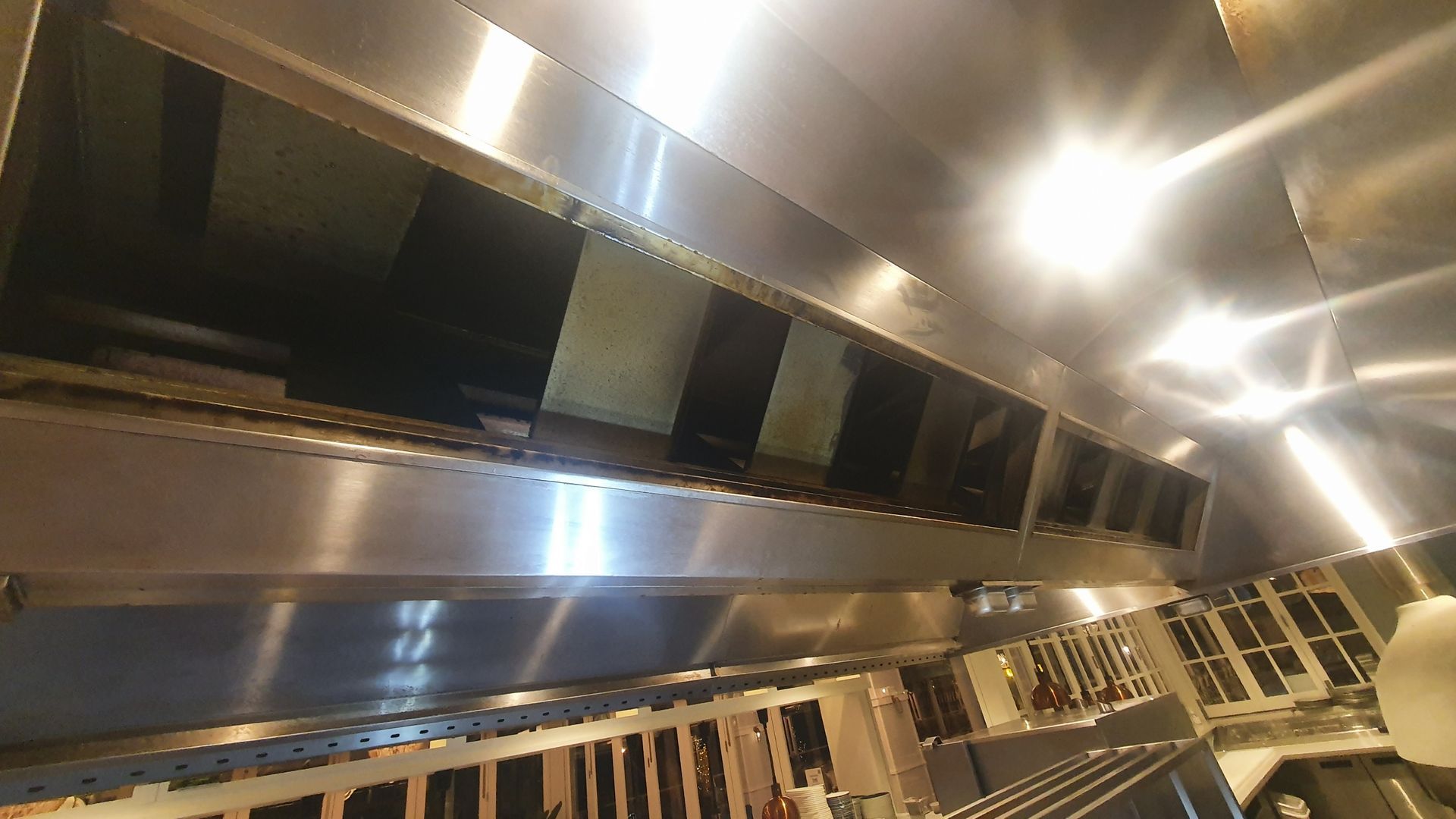 Stainless Steel Kitchen Hood Above Commercial Cooking — Central Coast Commercial Kitchen Cleaning in Tuggerah, NSW