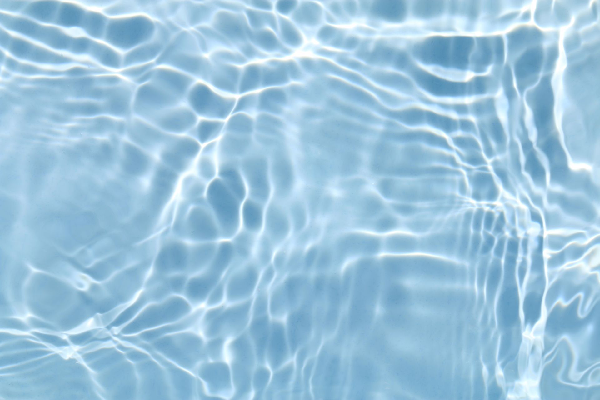 A close up of a blue water surface in a swimming pool.