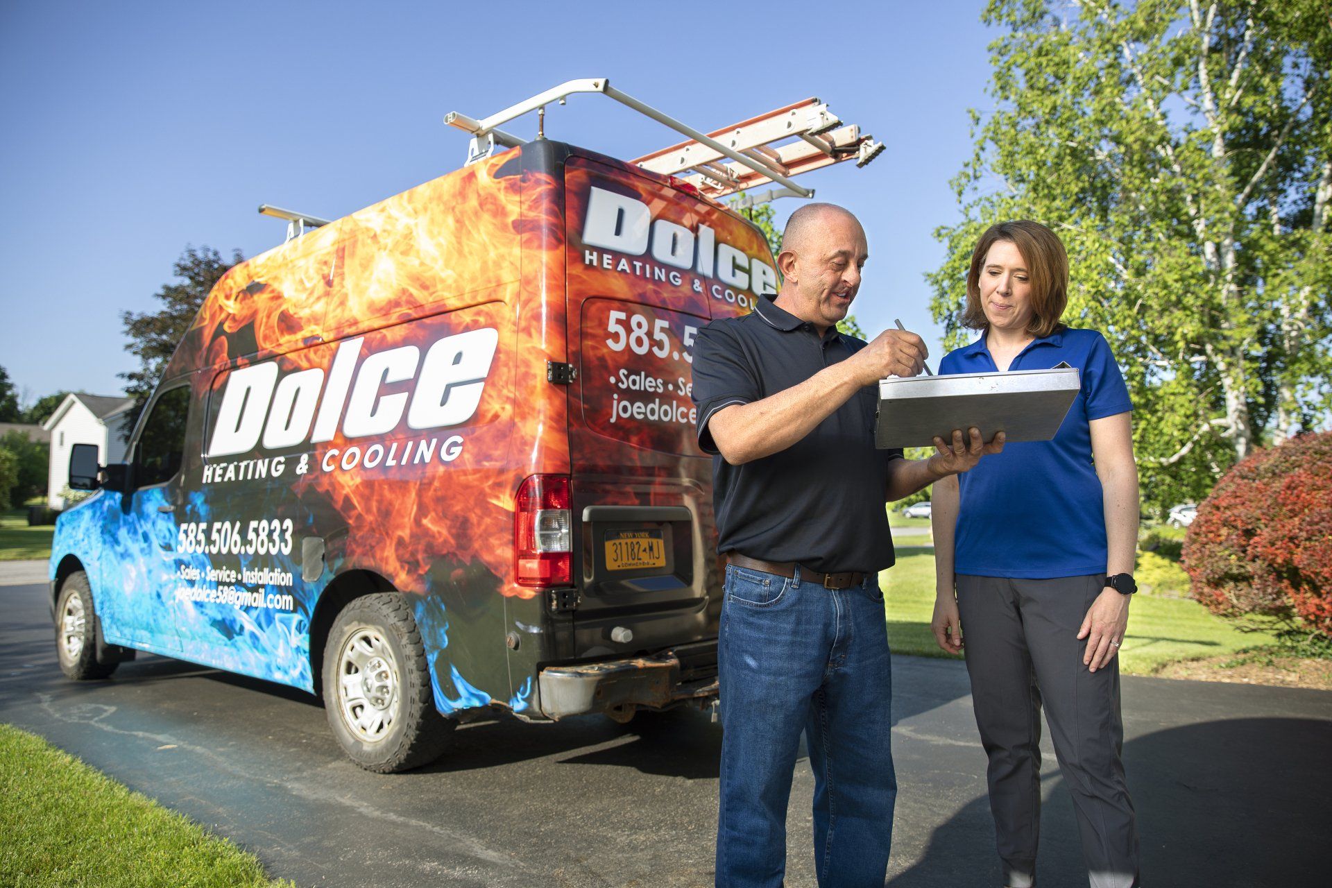 Owner Joe Dolce reviewing paperwork with a customer after installation