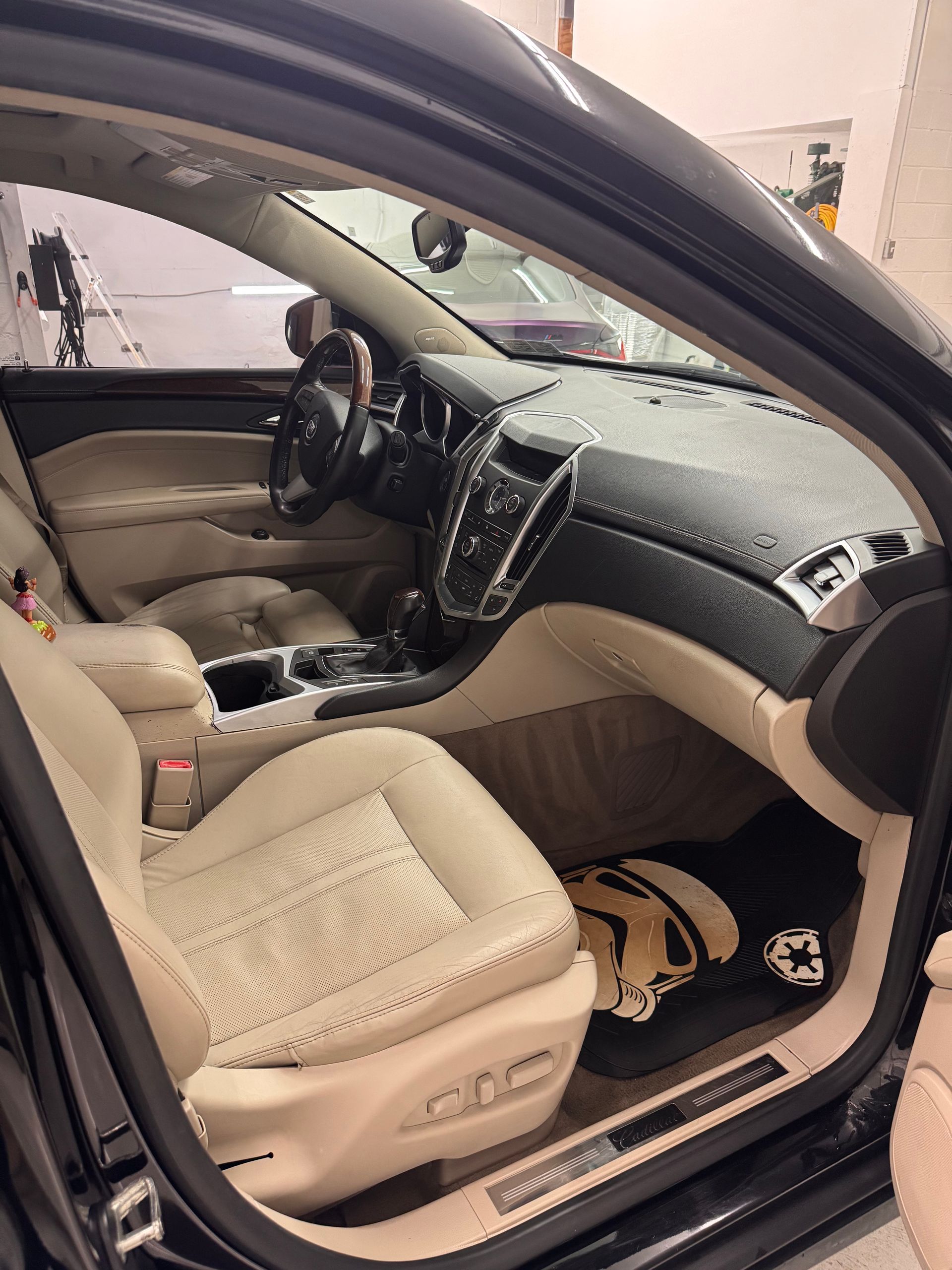 Black car interior with tan leather seats and a black dashboard.