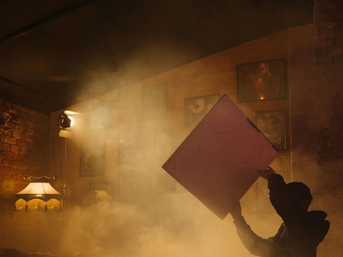 A person is fanning smoke in a restaurant.