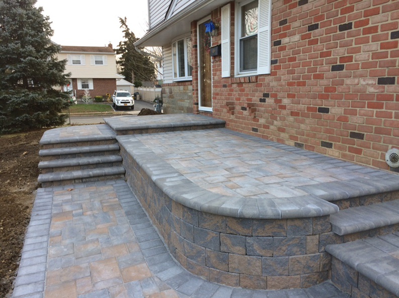 Brick home with a brick paver porch and steps.