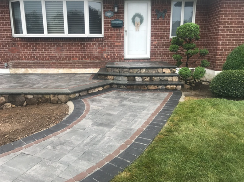 Brick house with paver pathway, steps, and landscaping.
