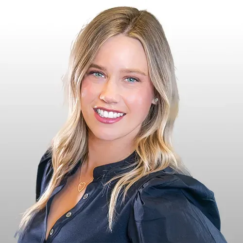 A close up of a woman 's face wearing a blue shirt