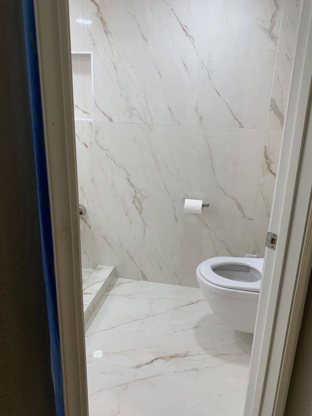 Modern concrete bathroom with sleek design and minimalist fixtures.