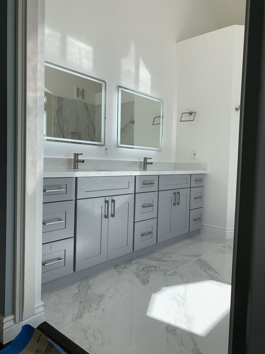 A modern and well-lit bathroom with a sink, and toilet.