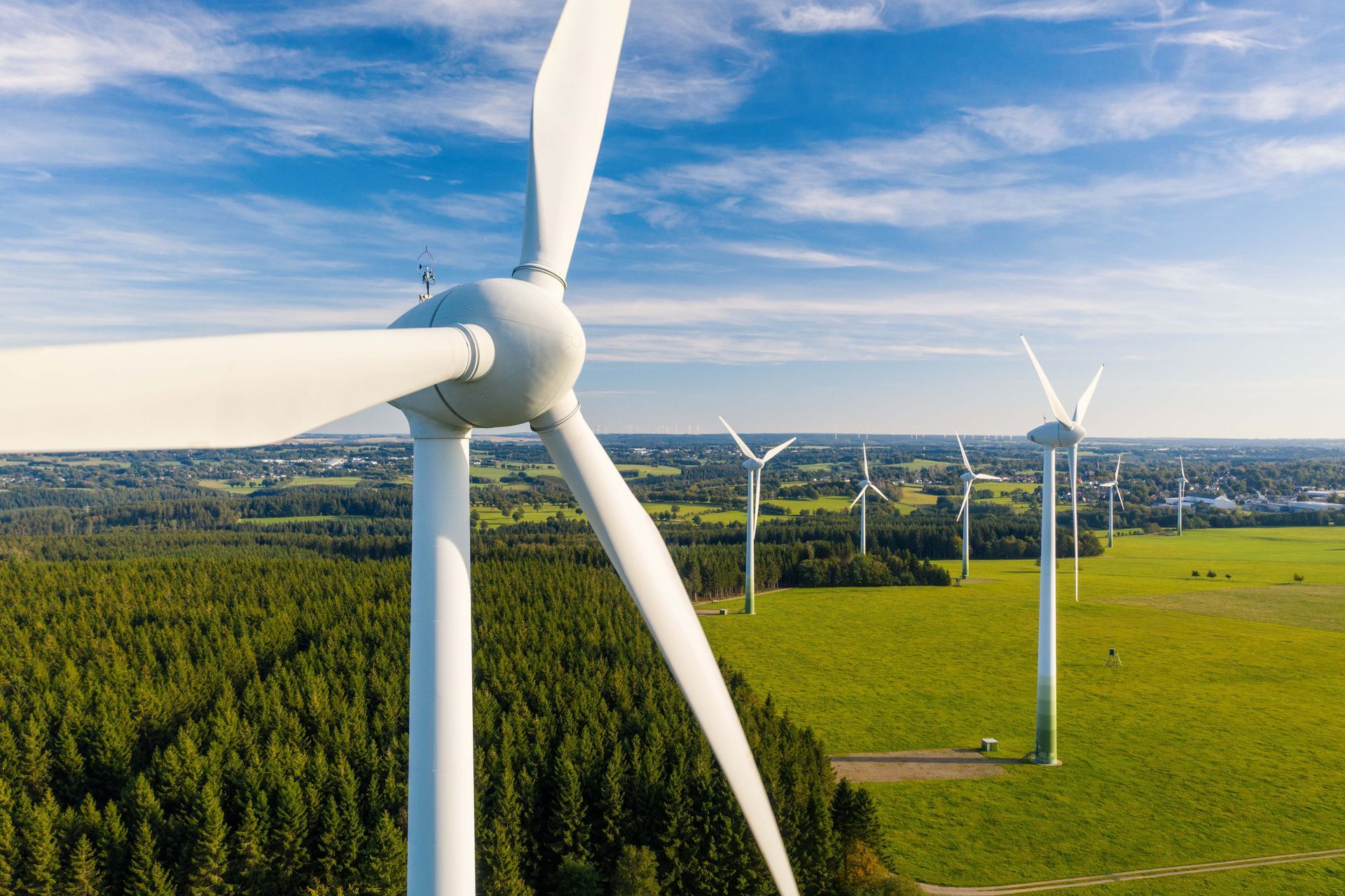 Une vue aérienne d'une rangée d'éoliennes dans un champ.