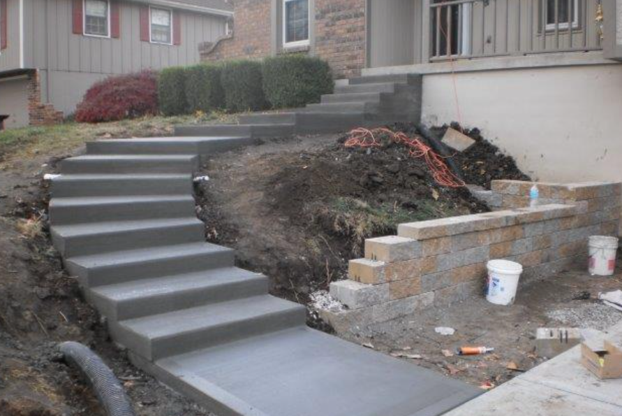 a set of concrete stairs leading up to a house .
