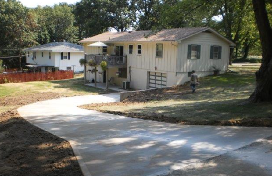 a house with a concrete driveway in front of it