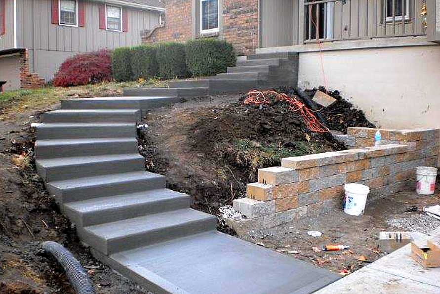 a set of concrete stairs leading up to a house .