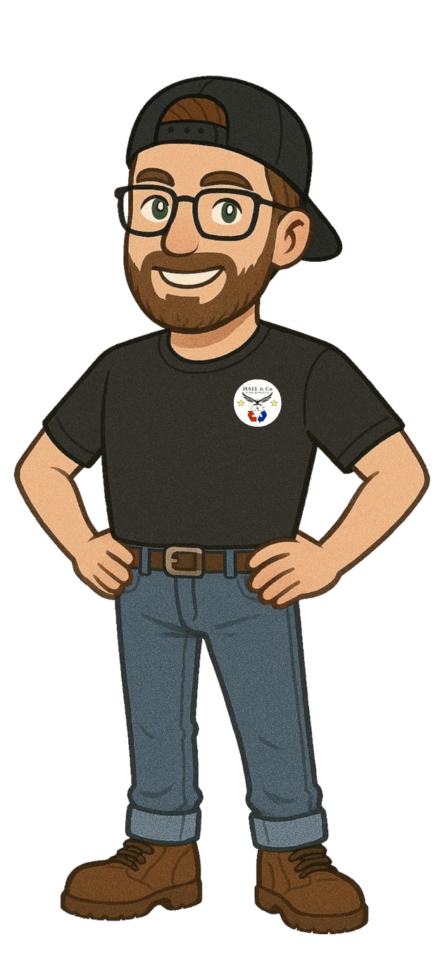 Person with glasses and a beard wearing a black shirt, jeans, and a baseball cap with hands on hips.