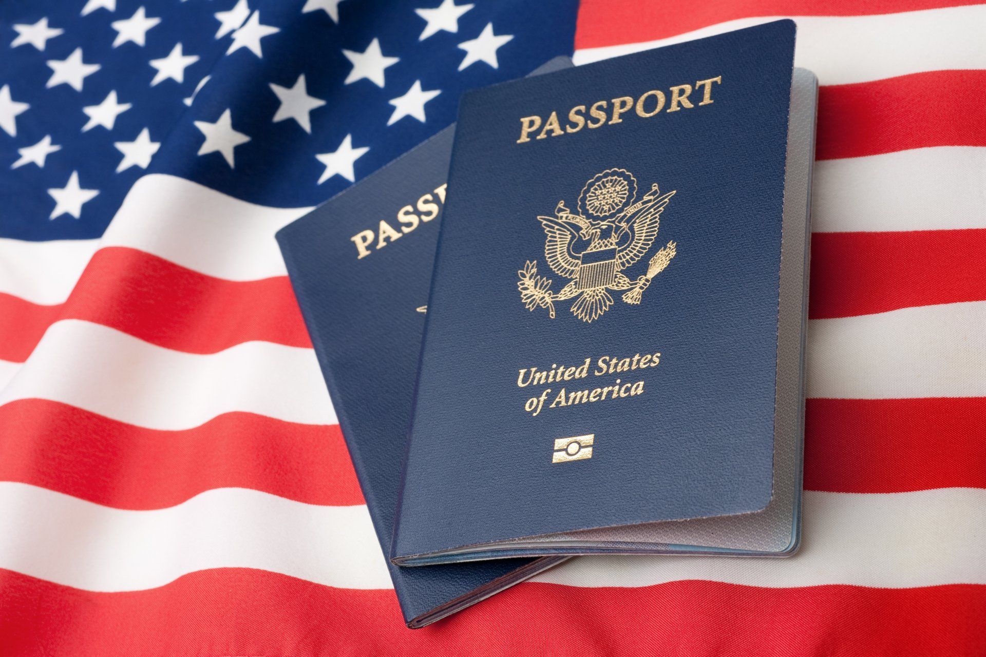 Two Passport Books With American Flag