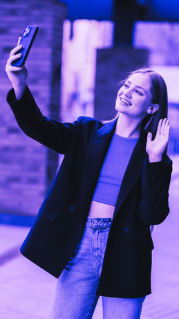 A woman is taking a selfie with her cell phone.