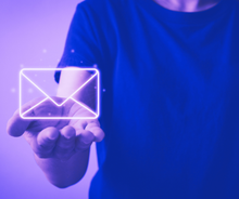 A person is holding a glowing envelope in their hand.