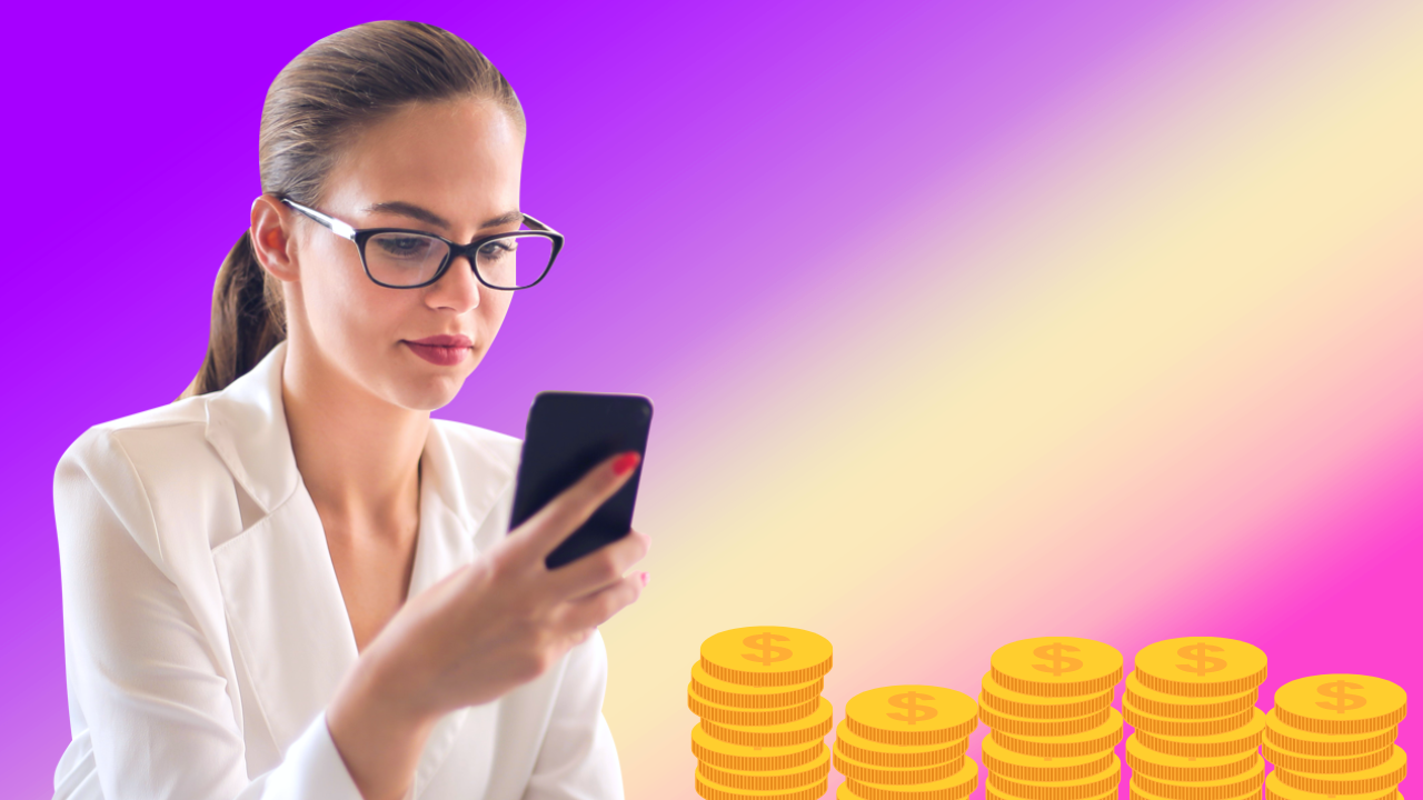 A woman is looking at her cell phone in front of stacks of coins.