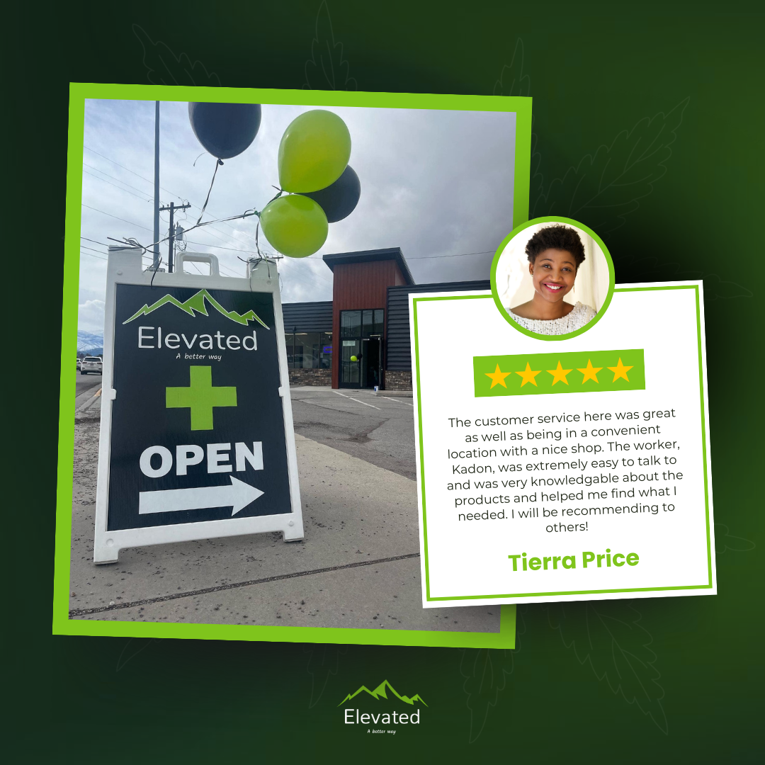 A sign outside Elevated Dispensary with green balloons, a customer review, and a woman's headshot.