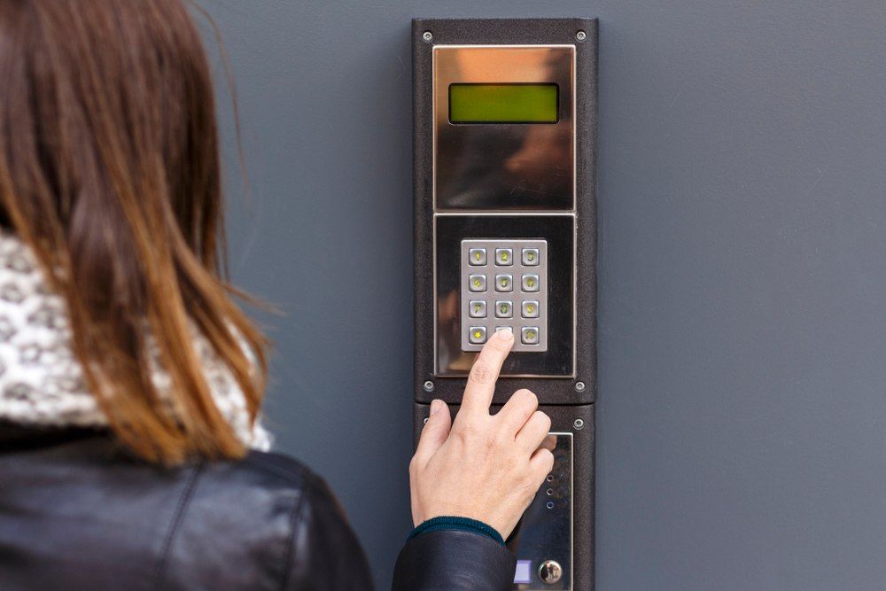 Person Entering Code on Keypad — X-Mod Security In Landsborough, QLD