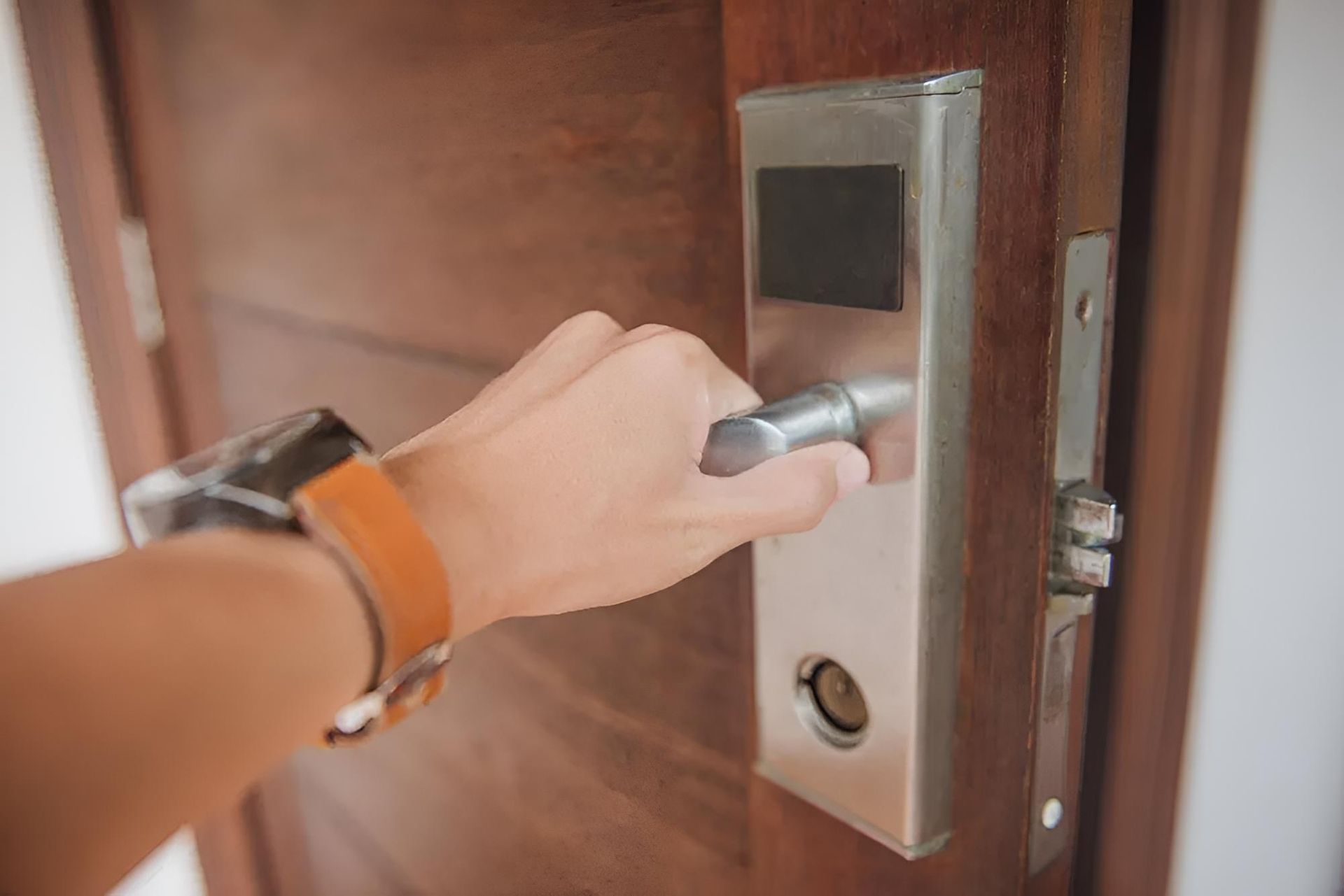 Person's Hand Gripping a Silver Door Handle — X-Mod Security In Landsborough, QLD
