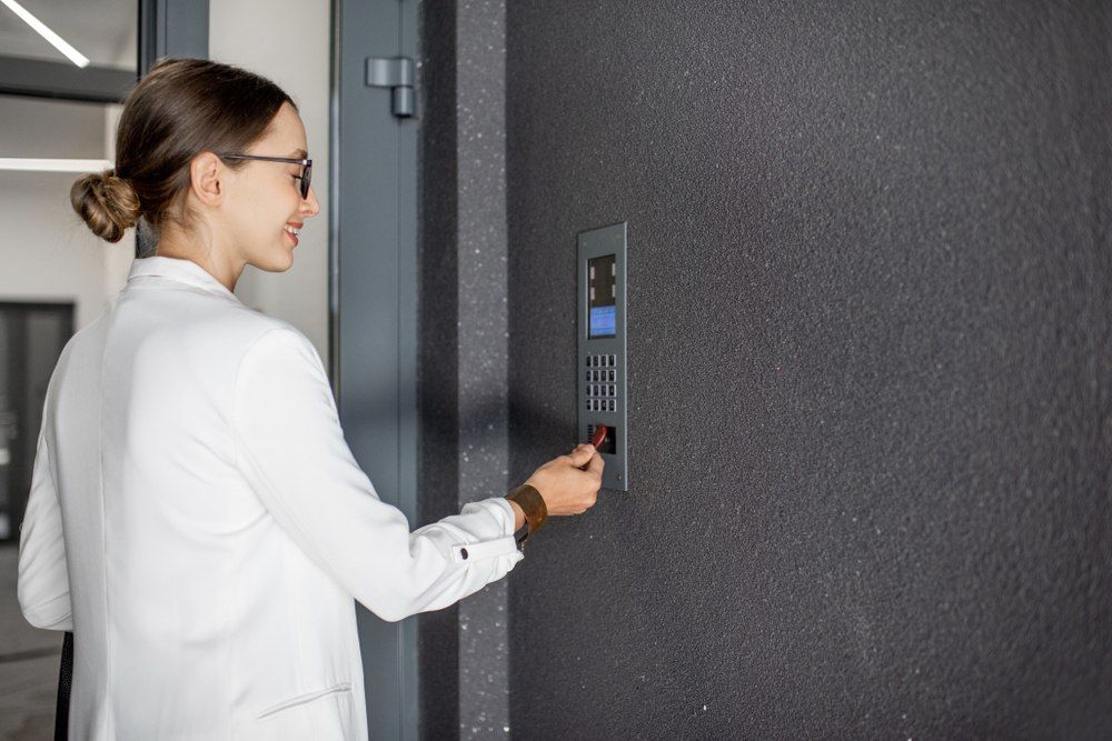 Woman in White Jacket Swipes Key Card — X-Mod Security In Landsborough, QLD