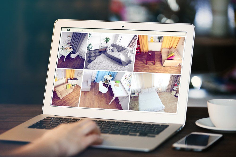 Person Using a Laptop Displaying Multiple Interior Room — X-Mod Security In Landsborough, QLD