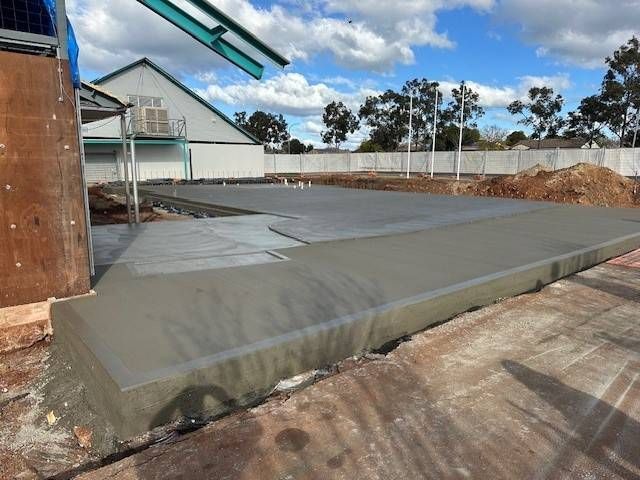 A Concrete Slab Is Sitting In The Middle Of A Dirt Field — Lonnie Henderson Concreting In Dubbo, NSW
