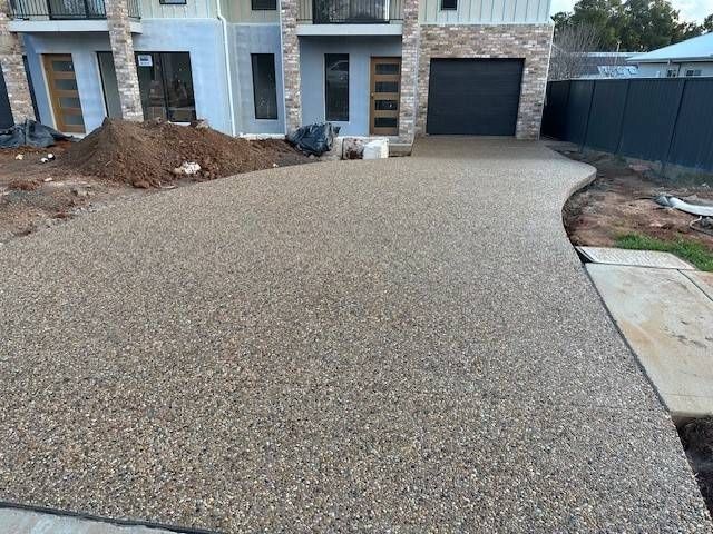 A House With A Driveway And A Fence In Front Of It — Lonnie Henderson Concreting In Dubbo, NSW