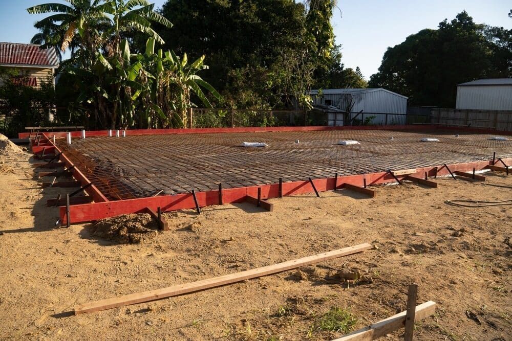 A Concrete Slab Is Being Built In A Dirt Field — Lonnie Henderson Concreting In Dubbo, NSW