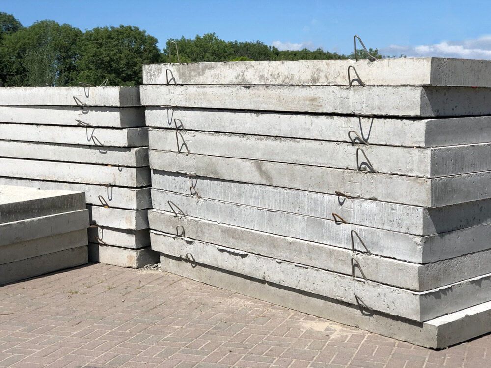 A Stack Of Concrete Slabs Sitting On Top Of Each Other On A Brick Sidewalk — Lonnie Henderson Concreting In Dubbo, NSW