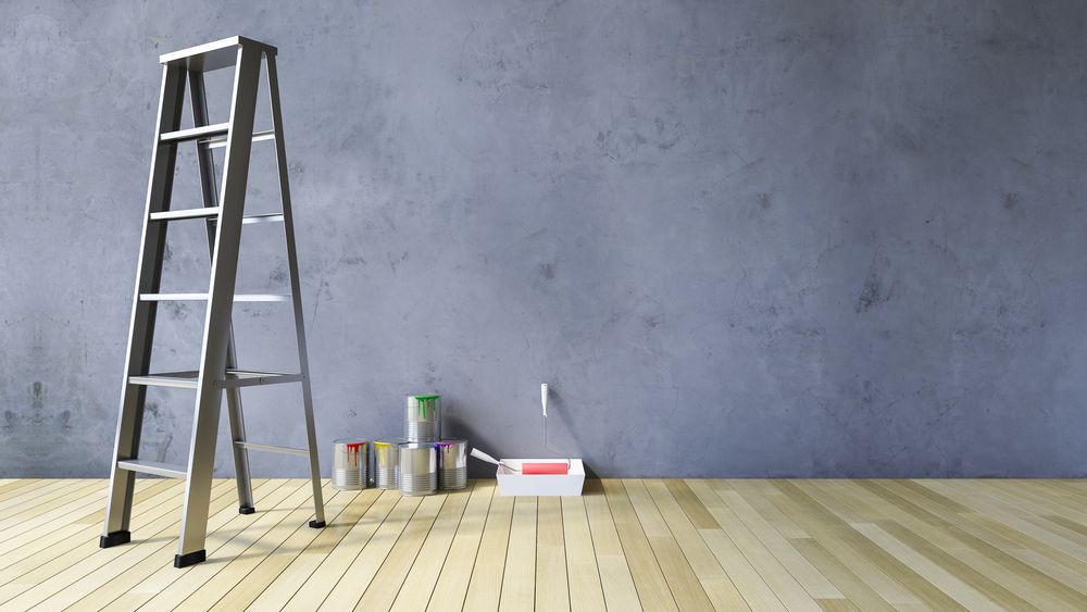 Ladder Leaning Against a Gray Wall With Paint Cans — Israel Jones Painting in Castle Hill, QLD