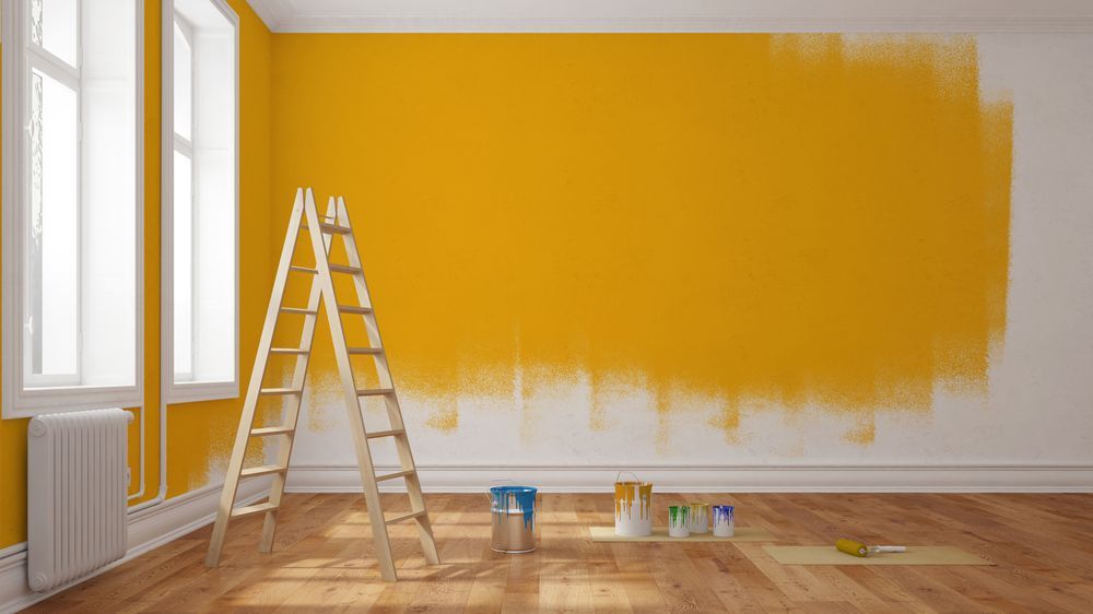 A Room Being Painted Yellow; a Ladder, and Paint Cans — Israel Jones Painting in Castle Hill, QLD