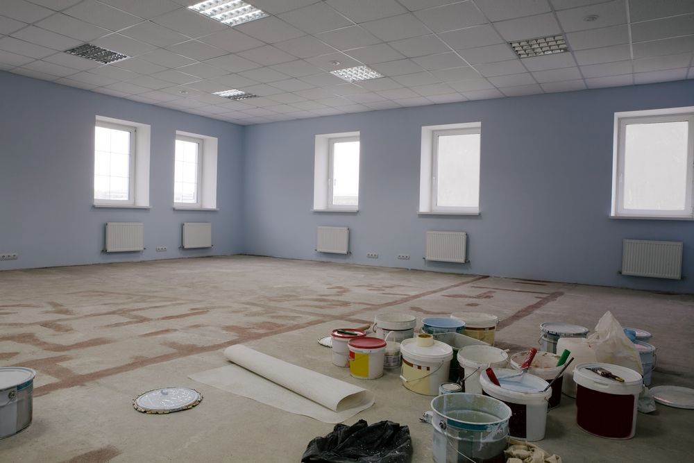 Empty Room, Light Blue Walls, Windows, Paint Buckets, and Supplies — Israel Jones Painting in Rowes Bay, QLD