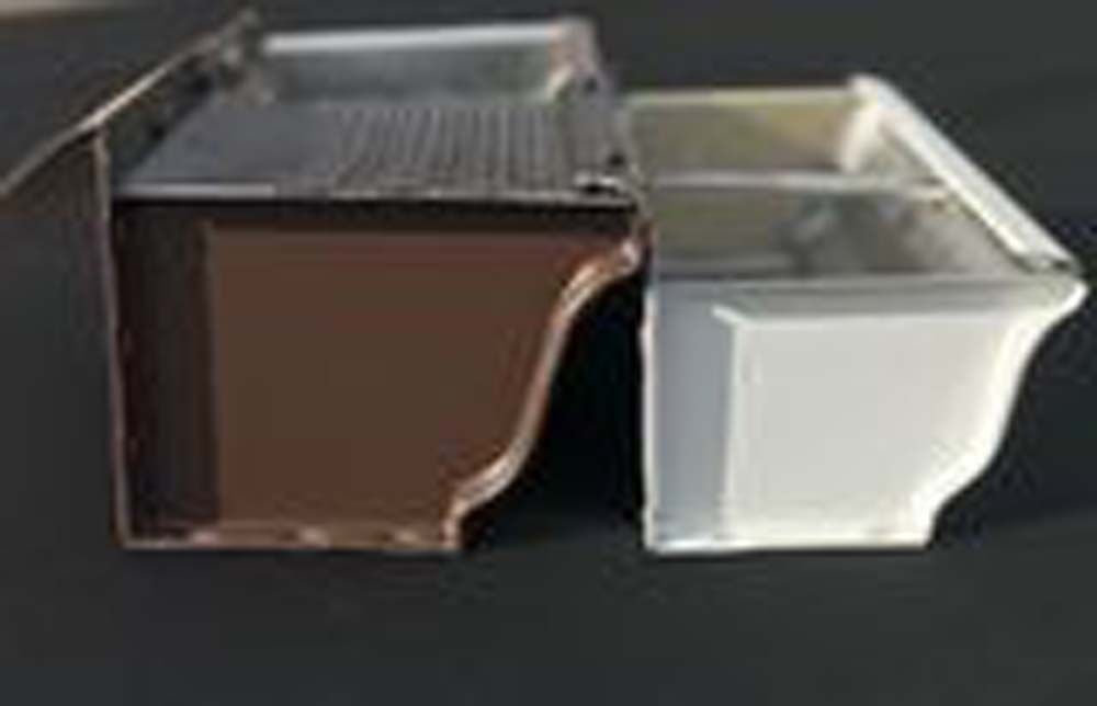 Two gutters , one brown and one white , are sitting next to each other on a table.